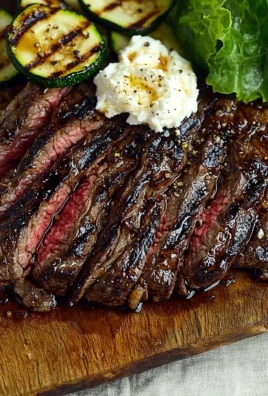 Grilled balsamic flank steak served with zucchini and whipped feta on a plate