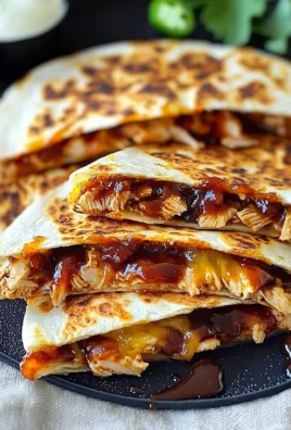 Blackstone BBQ chicken quesadillas drizzled with hot honey glaze