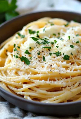 Delicious plate of Garlic Parmesan Spaghetti topped with fresh parsley and cheese