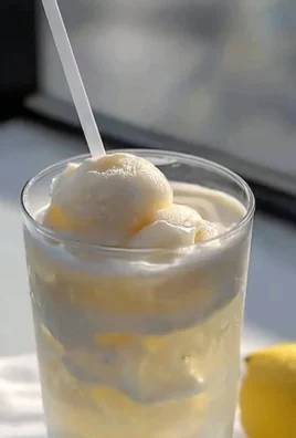 Chick-fil-A Frosted Lemonade in a clear cup with a lemon slice garnish