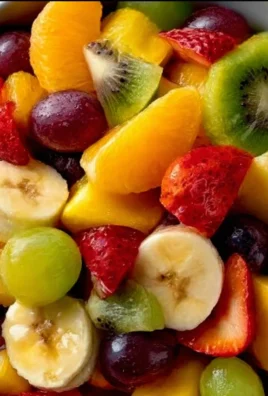 A vibrant bowl of mixed fruit salad featuring strawberries, blueberries, kiwi, and oranges.