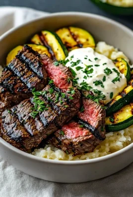 Delicious grilled steak bowl with sauce and grilled zucchini