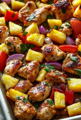 Hawaiian chicken sheet pan with colorful vegetables and pineapple