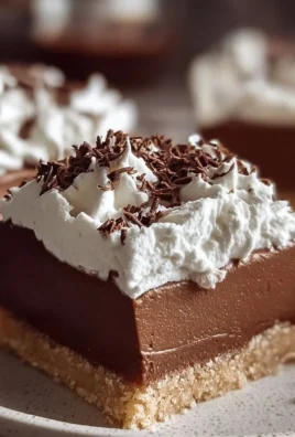 Delicious French Silk Pie Bars topped with whipped cream and chocolate shavings