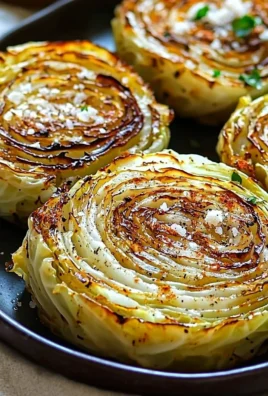 Roasted cabbage steaks garnished with herbs and spices on a plate.