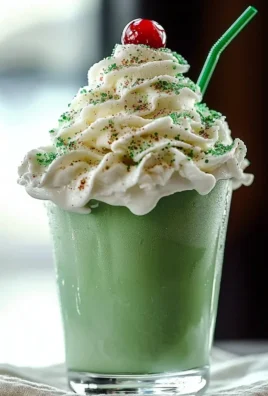 Delicious Shamrock Shake served in a festive cup with whipped cream and a green straw.
