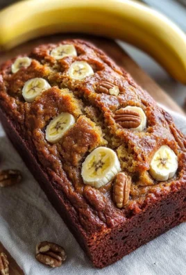 Loaf of freshly baked banana bread on a wooden table