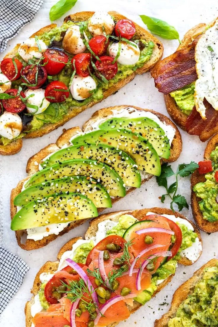 A delicious plate of avocado toast topped with fresh ingredients.