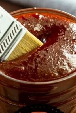 Homemade BBQ sauce in a jar with fresh ingredients