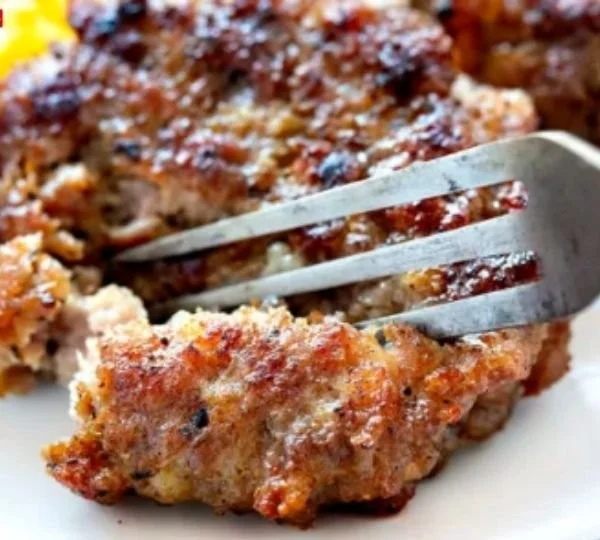 Homemade breakfast sausage patties sizzling in a skillet