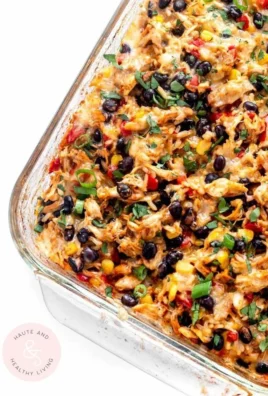 Delicious chicken burrito casserole topped with cheese and fresh vegetables