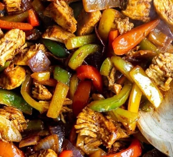 A vibrant Chicken Fajita Bowl filled with grilled chicken, peppers, and rice.
