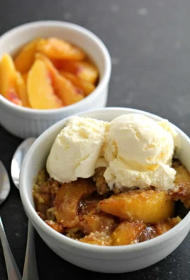 Delicious easy Instant Pot peach cobbler served in a bowl with a scoop of ice cream