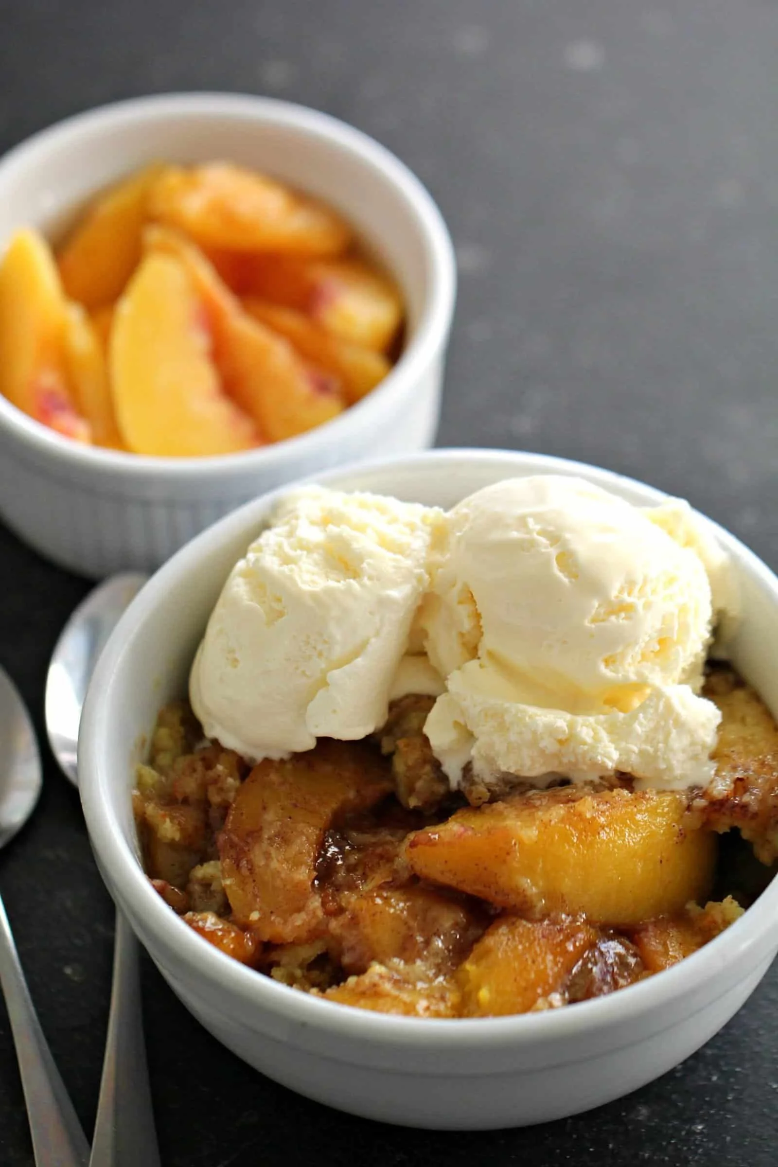 Delicious easy Instant Pot peach cobbler served in a bowl with a scoop of ice cream