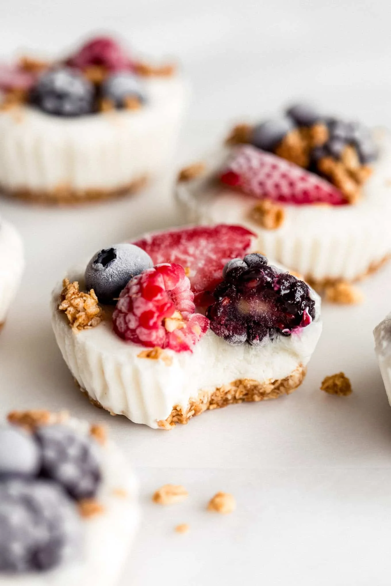Frozen yogurt granola cups topped with fresh fruit and nuts