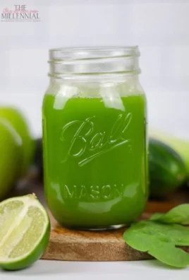 A vibrant green juice in a glass with fresh vegetables and fruits, perfect for beginners.