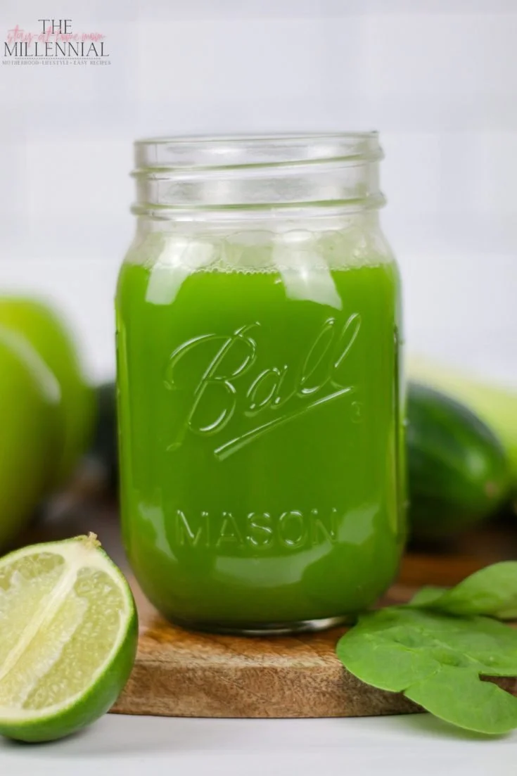 A vibrant green juice in a glass with fresh vegetables and fruits, perfect for beginners.