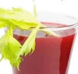 Homemade V8 juicer recipe ingredients and final juice in a glass