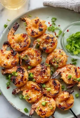Grilled Bang Bang Shrimp skewers served with spicy dipping sauce