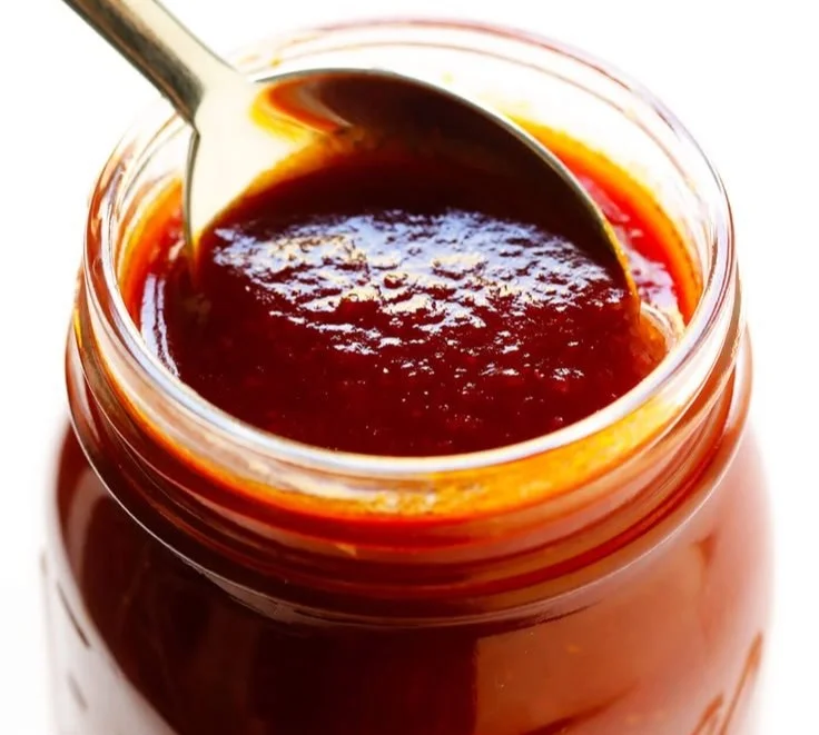 Jar of Kansas City-style homemade BBQ sauce with spices and ingredients