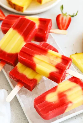 Colorful lava flow popsicles melting on a sunny day, perfect summer treat.