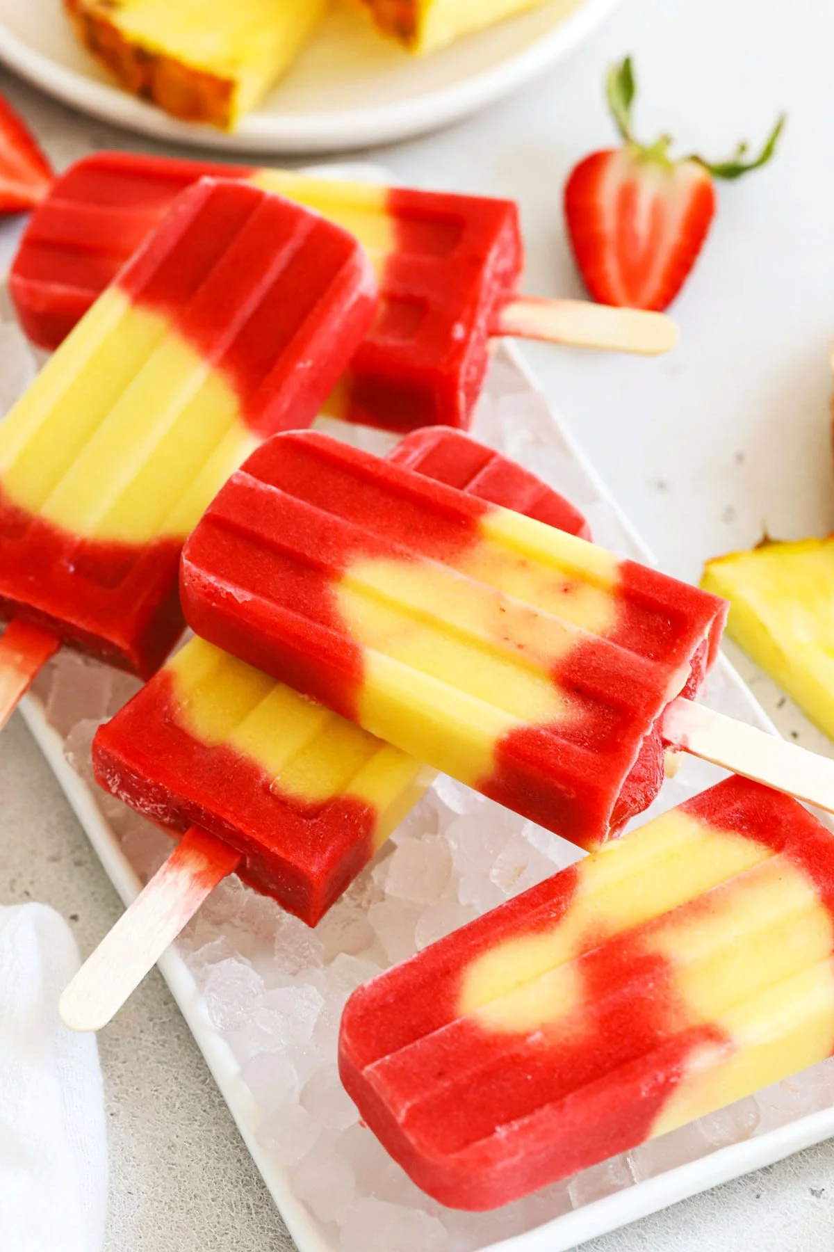 Colorful lava flow popsicles melting on a sunny day, perfect summer treat.