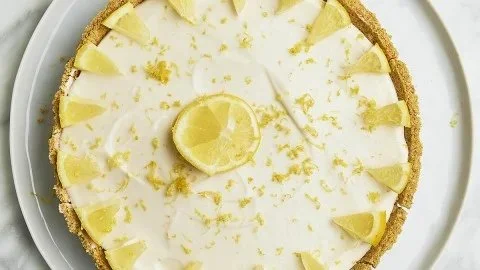 Delicious slice of lemon cheesecake topped with fresh lemon slices