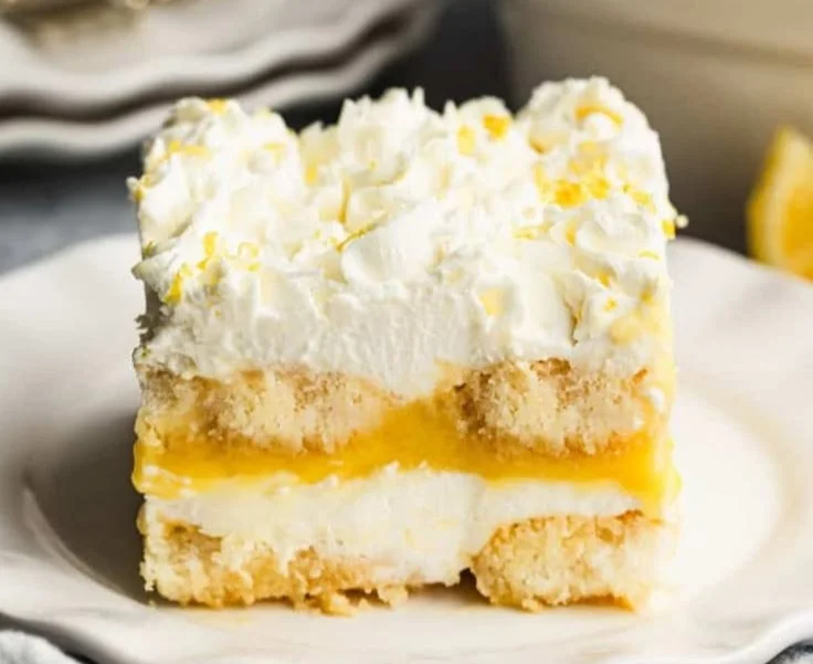Delicious slice of lemon tiramisu garnished with lemon zest and mint leaves