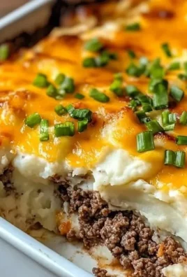 Loaded Steakhouse Mashed Potato Casserole topped with cheese and herbs