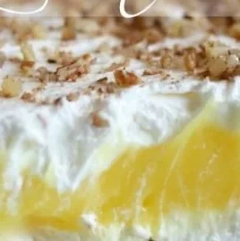 Delicious slice of Luscious Lemon Delight dessert topped with lemon zest