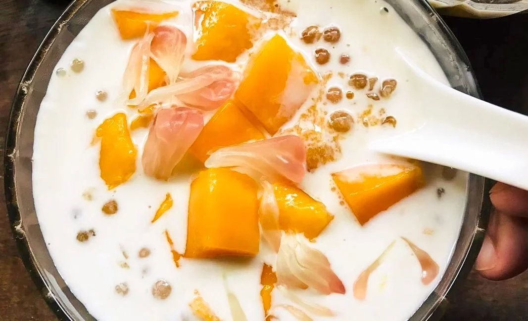 Mango Pomelo Sago dessert served in a bowl topped with fresh mango and pomelo.
