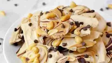Peanut Butter Chocolate Frozen Yogurt Bark served on a plate with toppings