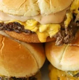 Delicious smash burgers with juicy patties and fresh toppings served on a plate.