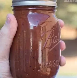 Homemade Texas style BBQ sauce in a jar, perfect for grilling and marinades.