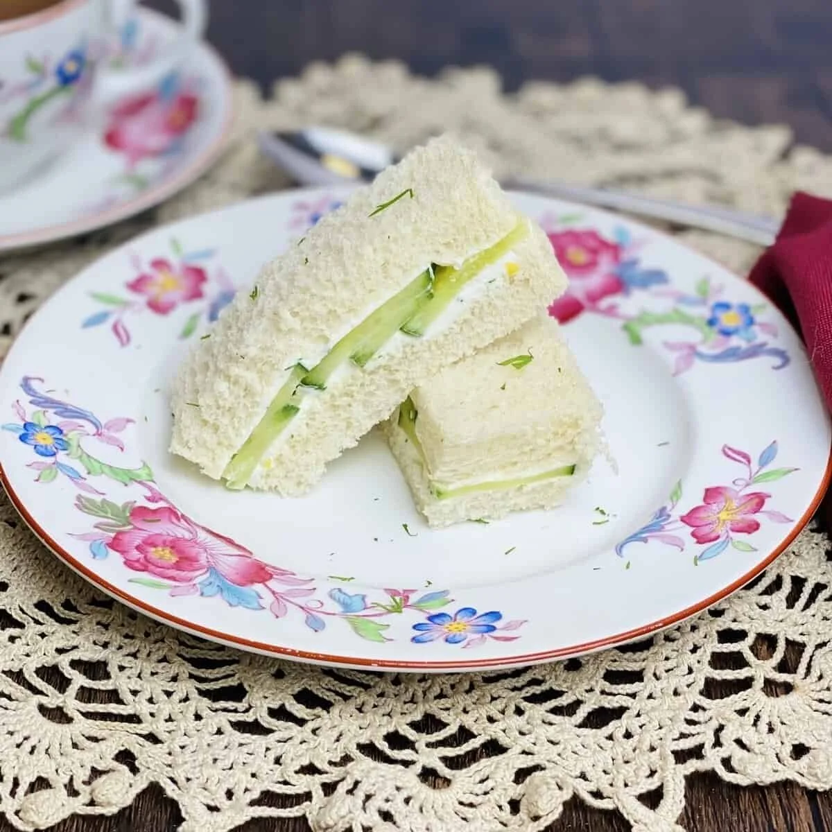 Plate of traditional cucumber sandwiches ready for serving at a tea party.