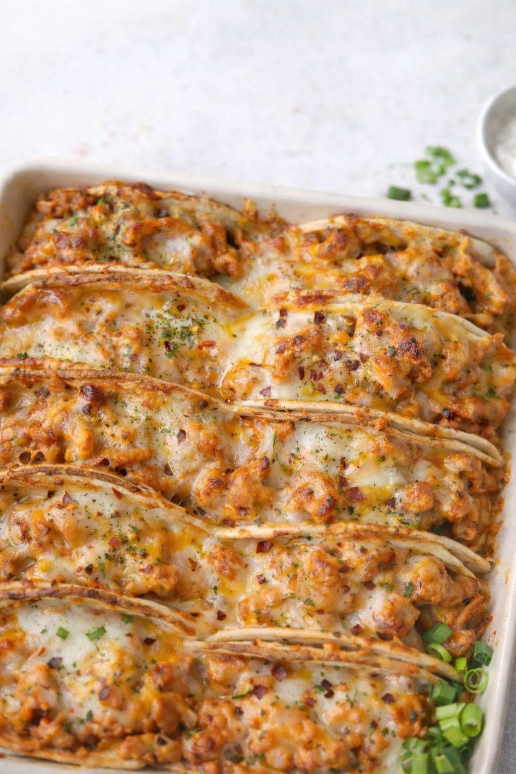 Baked chicken bacon ranch tacos garnished and ready to serve.