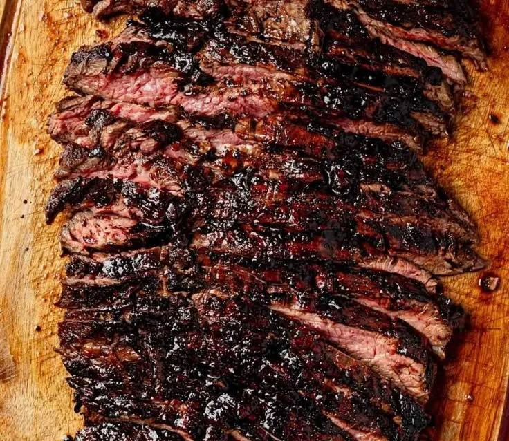 Grilled balsamic flank steak with zucchini and whipped feta on a plate