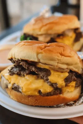 Delicious Blackstone smash burgers cooking on a grill