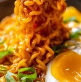 Creamy Buldak Cheese Ramen served in a bowl with toppings