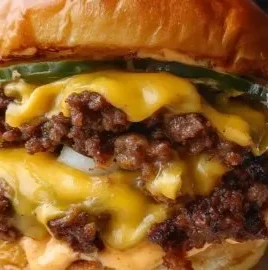 Crispy smash burger with lacy edges and delicious secret sauce on a grill