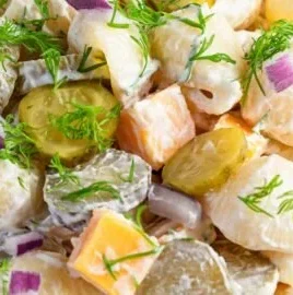Delicious Dill Pickle Pasta Salad in a bowl, garnished with fresh herbs.