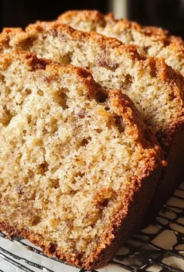 Delicious slice of easy moist banana bread on a wooden table.