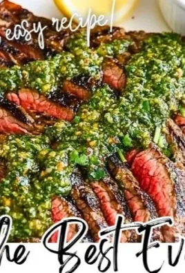 Grilled flank steak topped with vibrant chimichurri sauce on a wooden cutting board.