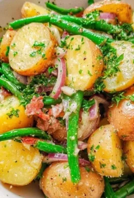 Delicious French potato salad with green beans in a bowl, perfect for summer meals.