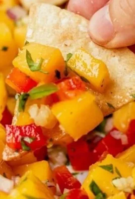 Bowl of fresh peach mango salsa with colorful diced fruits