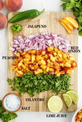 Bowl of fresh peach salsa with colorful ingredients including peaches, onions, and cilantro.