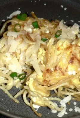 Delicious fried leftover spaghetti served on a plate with garnishes
