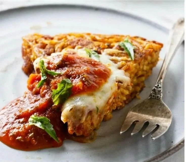 Plate of Fried Spaghetti with fresh herbs and spices garnished.