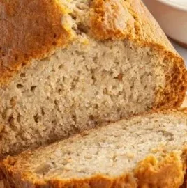 Slice of Greek Yogurt Banana Bread on a wooden table