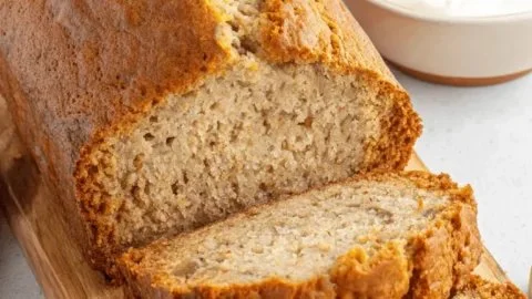 Slice of Greek Yogurt Banana Bread on a wooden table
